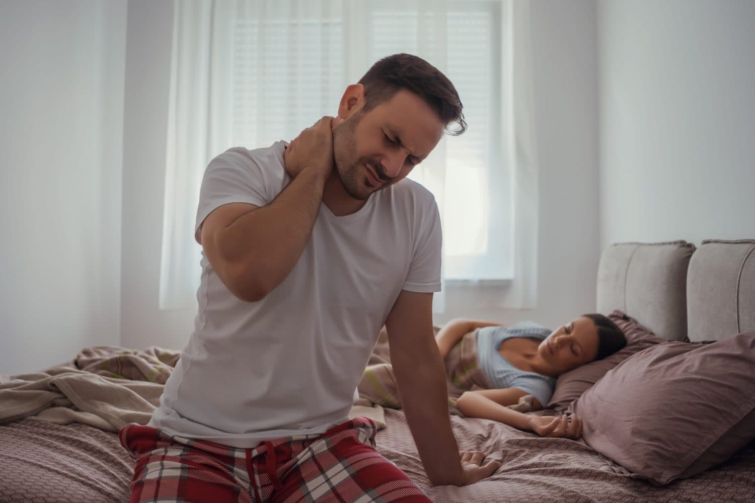 Woman with neck pain after waking up