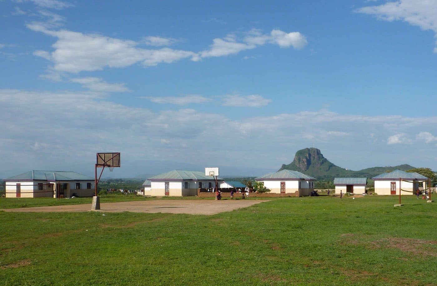 Children's homes built around a sports field at a school in Uganda