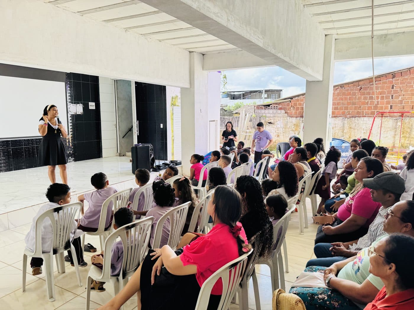 Em speaking to a room full of children and their parents